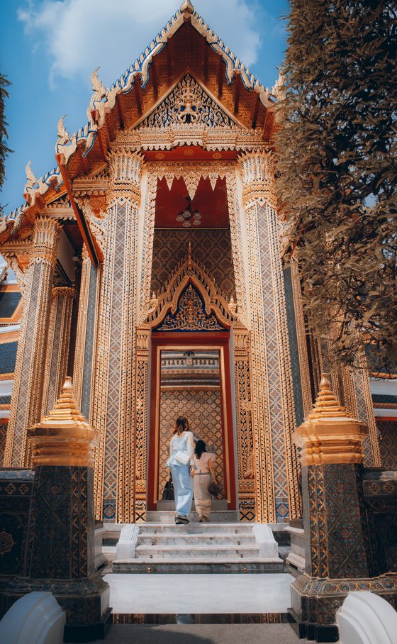 man and woman standing in front of brown concrete building during daytime