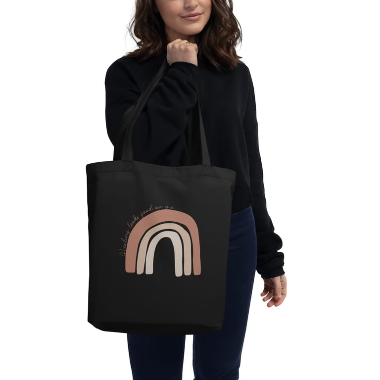 woman-holding-eco-tote-bag-black-healing-looks-good-one-me-quote