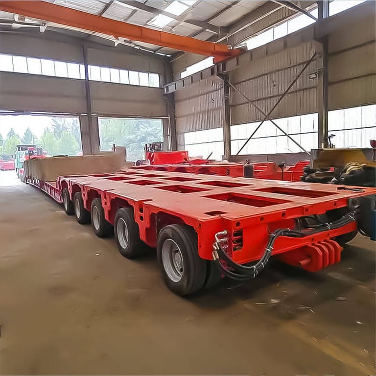 Rear three-quarter view of Nicolas Heavy Duty Modular Trailer highlighting axle configuration and hydraulic suspension system Rear three-quarter view of Nicolas Heavy Duty Modular Trailer highlighting axle configuration and hydraulic suspension system