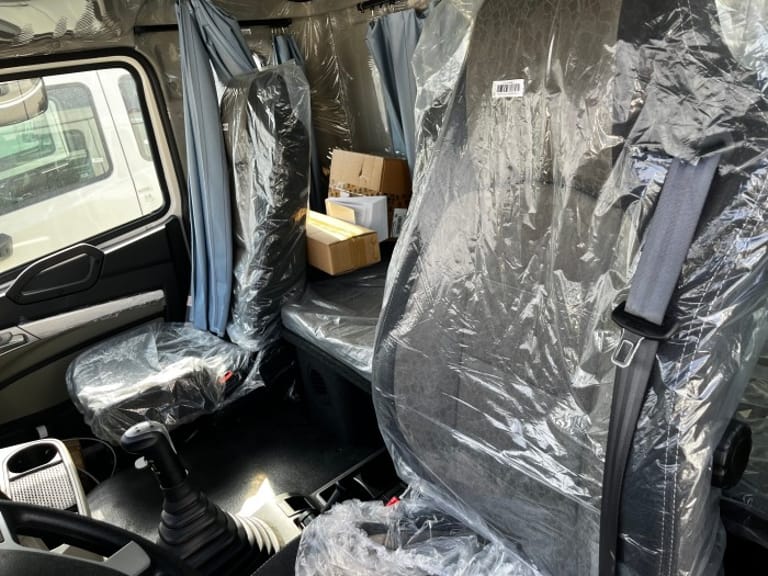 HOWO NX 380HP dump truck cabin close-up with H77L sleeper interior and air-conditioning features HOWO NX 380HP dump truck cabin close-up with H77L sleeper interior and air-conditioning features