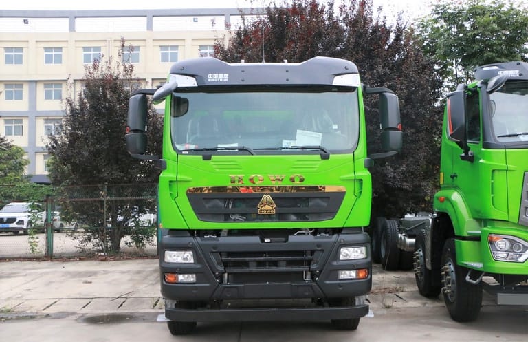 Front view of HOWO TX 430HP 8X4 6.5m Dump Truck showing reinforced steel bumper, high-roof cabin, and 12.00R20 tires for heavy-duty construction and mining applications Front view of HOWO TX 430HP 8X4 6.5m Dump Truck showing reinforced steel bumper, high-roof cabin, and 12.00R20 tires for heavy-duty construction and mining applications