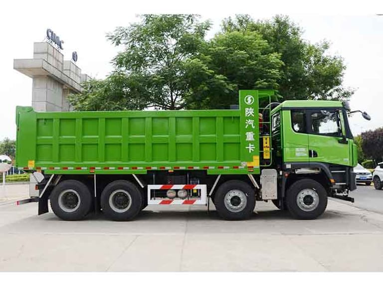 Shacman X5000 8X4 430HP dump truck side view showing full-length reinforced steel cargo bed and heavy-duty wheels