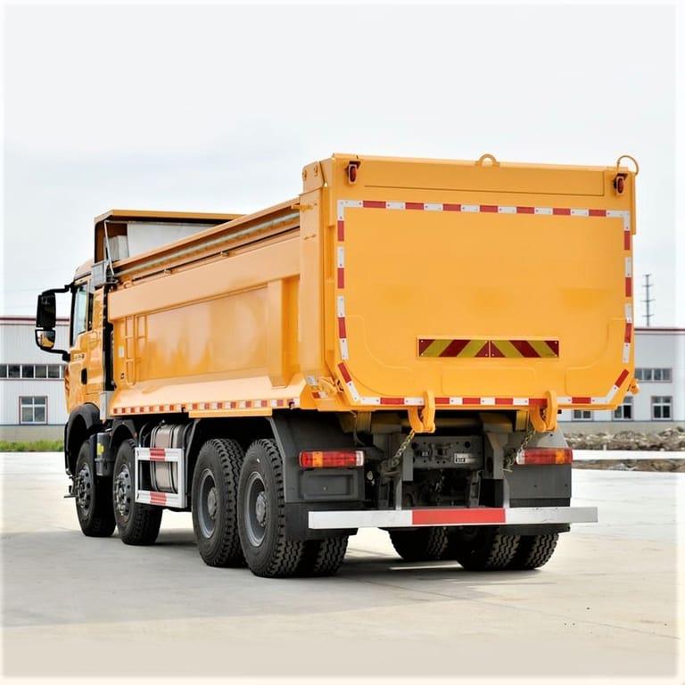 HOWO TX 8x4 440HP dump truck rear 3/4 angle showing hydraulic tipping mechanism and rear wheels HOWO TX 8x4 440HP dump truck rear 3/4 angle showing hydraulic tipping mechanism and rear wheels
