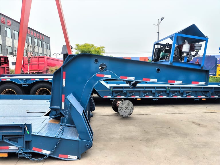 Close-up of removable gooseneck of ZW Group 3 Axle 80T RGN Lowbed Semi Trailer showing hydraulic lifting mechanism and high-strength HG60 steel construction Close-up of removable gooseneck of ZW Group 3 Axle 80T RGN Lowbed Semi Trailer showing hydraulic lifting mechanism and high-strength HG60 steel construction