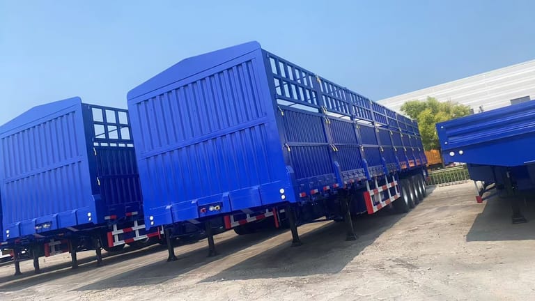 60 Ton Fence Trailer for sale front three-quarter view — displaying the strong fence structure, reinforced chassis, and high-capacity loading area designed for bulk cargo transport. 60 Ton Fence Trailer for sale front three-quarter view — displaying the strong fence structure, reinforced chassis, and high-capacity loading area designed for bulk cargo transport.