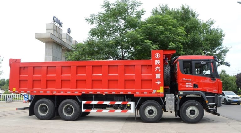 Shacman X3000 8X4 Dump Truck side profile showing 8.8m steel cargo body and reinforced chassis for heavy-duty construction and mining transport Shacman X3000 8X4 Dump Truck side profile showing 8.8m steel cargo body and reinforced chassis for heavy-duty construction and mining transport