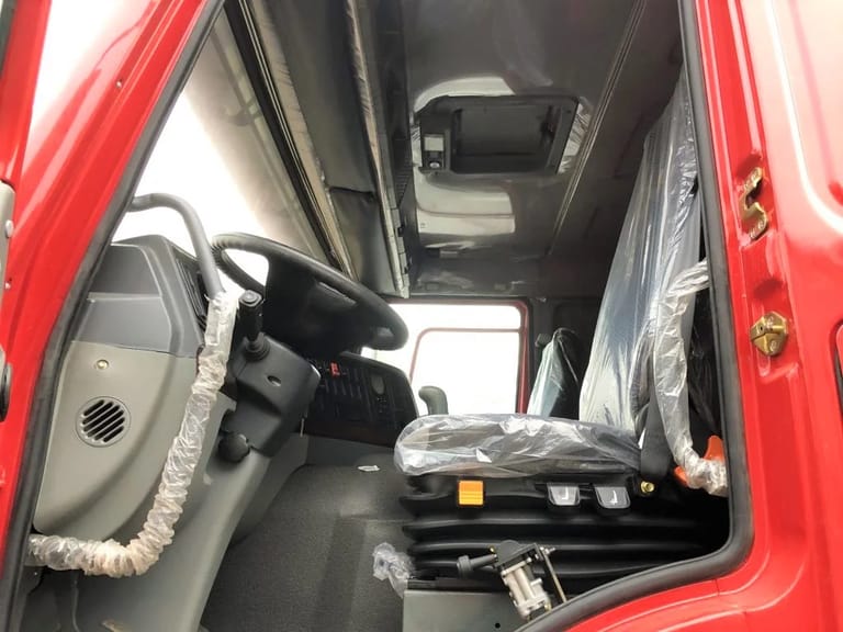 Cabin interior of Used HOWO 375HP 6×4 Dump Truck, showing flat-roof sleeper and ergonomic controls Cabin interior of Used HOWO 375HP 6×4 Dump Truck, showing flat-roof sleeper and ergonomic controls