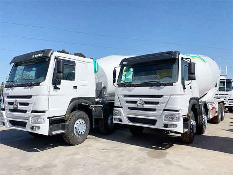Front three-quarter perspective of HOWO 8X4 High-Capacity Concrete Mixer Truck on site Front three-quarter perspective of HOWO 8X4 High-Capacity Concrete Mixer Truck on site