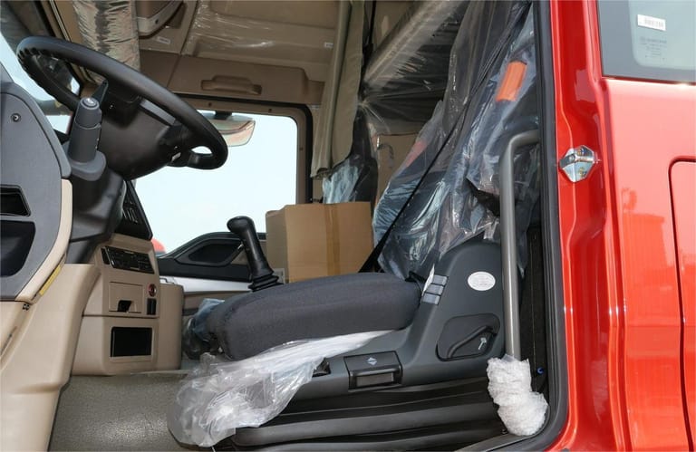 HOWO TX 430HP 6×4 tractor truck high-roof sleeper cabin close-up showing seats and dashboard controls HOWO TX 430HP 6×4 tractor truck high-roof sleeper cabin close-up showing seats and dashboard controls