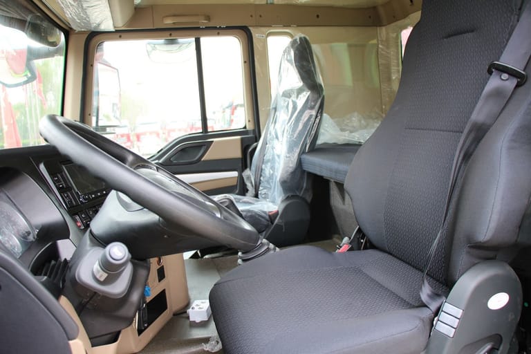 HOWO TX 460HP 8×4 Dump Truck cabin interior close-up showing driver seat, dashboard, and controls HOWO TX 460HP 8×4 Dump Truck cabin interior close-up showing driver seat, dashboard, and controls