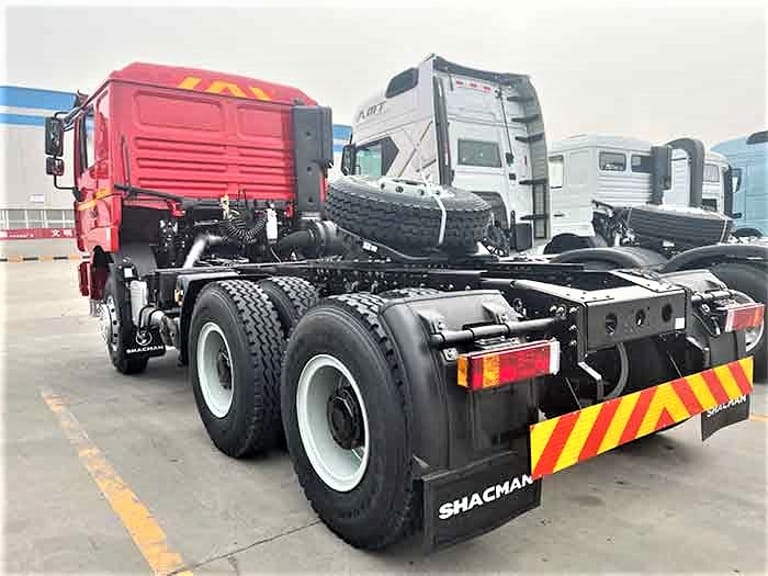 Shacman F3000 6x4 Tractor Truck rear three-quarter view highlighting chassis, rear axles, and high-capacity fuel tank for freight and logistics operations