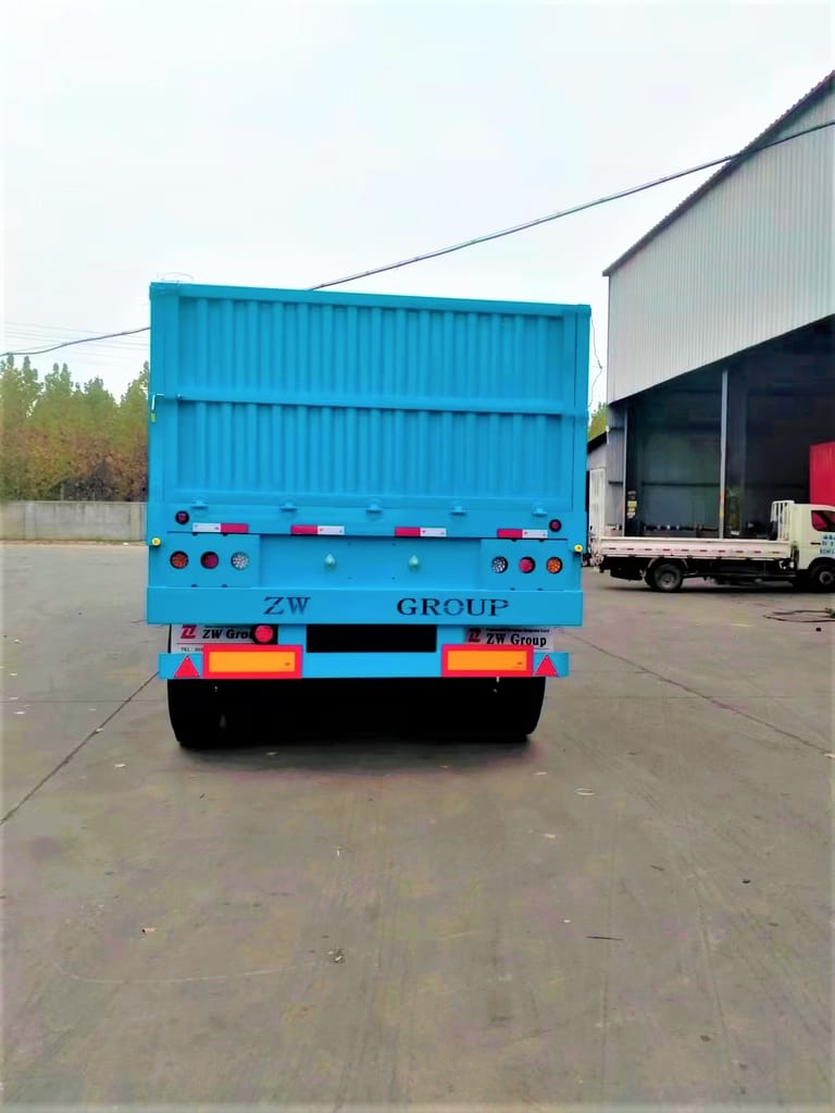 ZW Group 3 Axle 60T Side Wall Semi Trailer rear view highlighting 1200mm side walls, mechanical suspension, and heavy-duty tires ZW Group 3 Axle 60T Side Wall Semi Trailer rear view highlighting 1200mm side walls, mechanical suspension, and heavy-duty tires