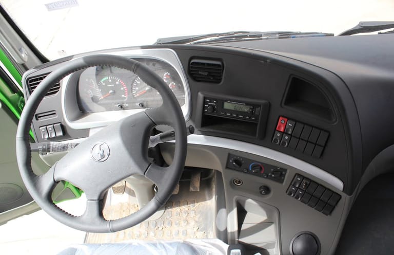 Shacman M3000 6X4 dump truck cabin interior, ergonomic air-suspension seat, climate control, and operator-friendly controls Shacman M3000 6X4 dump truck cabin interior, ergonomic air-suspension seat, climate control, and operator-friendly controls