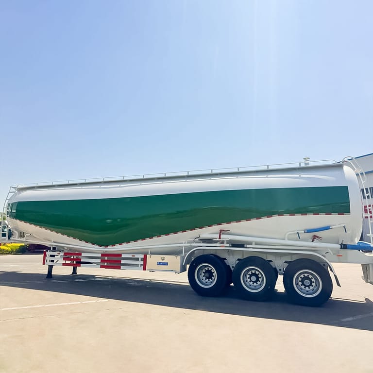 Side view of 3 Axle Dry Bulk Tanker Trailer – showing large-capacity tank, reinforced chassis, and three-axle design for stable dry bulk material transport. Side view of 3 Axle Dry Bulk Tanker Trailer – showing large-capacity tank, reinforced chassis, and three-axle design for stable dry bulk material transport.