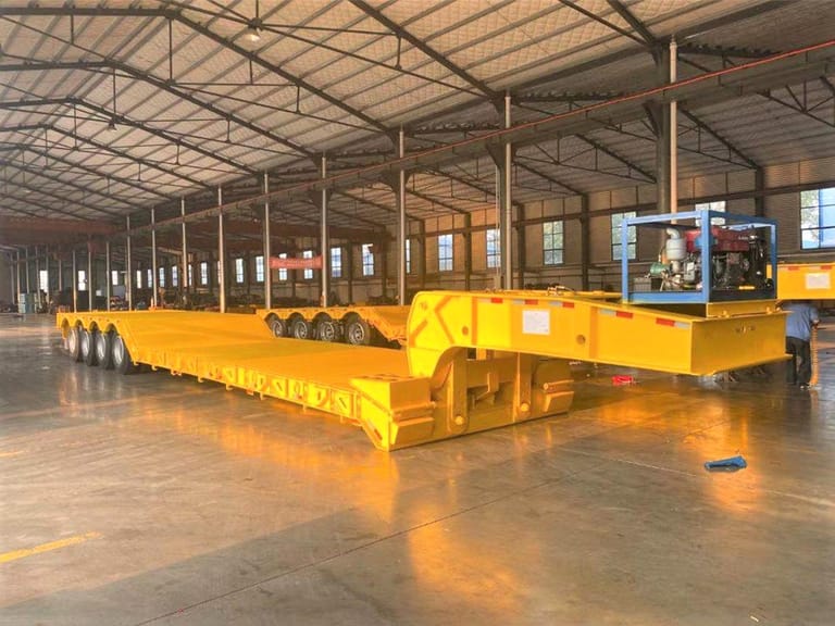 ZW Group 4 Axle 100 Ton Detachable Gooseneck Trailer front three-quarter view showing hydraulic gooseneck and heavy-duty steel chassis for oversized machinery transport ZW Group 4 Axle 100 Ton Detachable Gooseneck Trailer front three-quarter view showing hydraulic gooseneck and heavy-duty steel chassis for oversized machinery transport