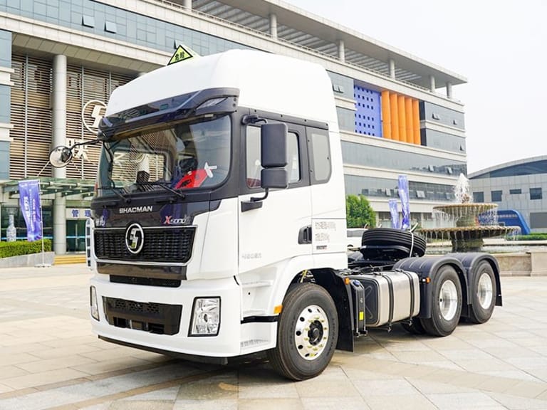 Shacman X5000 460HP 6x4 Tractor Truck front three-quarter view showing cab, chassis, and MAN axles optimized for hazardous material and long-distance transport