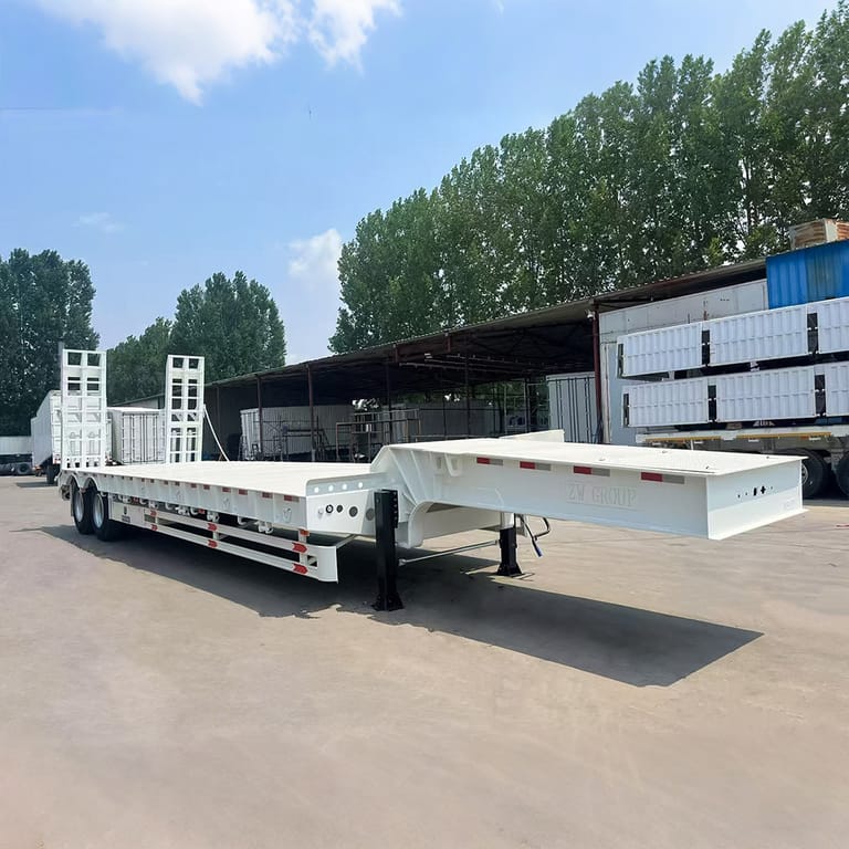 2 Axle 40 Ton Lowbed Semi Trailer front 3/4 view showing Q345B steel chassis and loading ramps — ZW Group lowbed trailer for heavy machinery transport. 2 Axle 40 Ton Lowbed Semi Trailer front 3/4 view showing Q345B steel chassis and loading ramps — ZW Group lowbed trailer for heavy machinery transport.