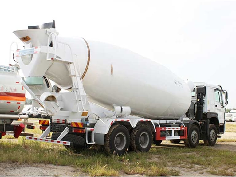 Rear three-quarter view of HOWO 380HP 8×4 Concrete Mixer Truck displaying drum discharge chute and rear axle configuration Rear three-quarter view of HOWO 380HP 8×4 Concrete Mixer Truck displaying drum discharge chute and rear axle configuration