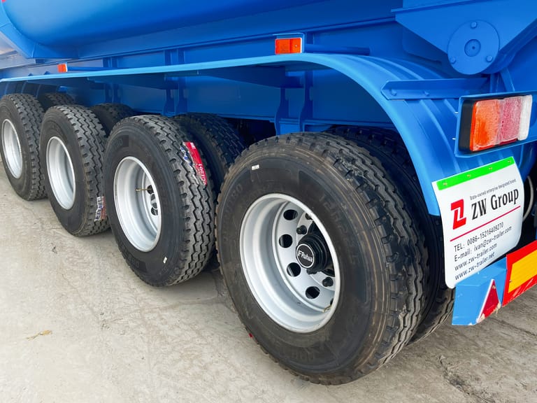 Close-up of tires on 4 Axle Tipper Semi Trailer – showing heavy-duty tires, strong rims, and reinforced suspension for reliable cargo transport. Close-up of tires on 4 Axle Tipper Semi Trailer – showing heavy-duty tires, strong rims, and reinforced suspension for reliable cargo transport.