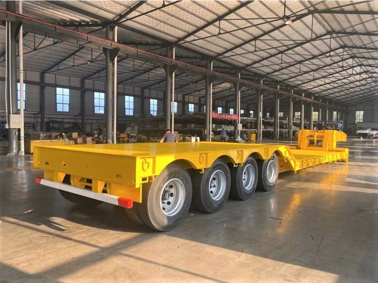 ZW Group 4 Axle 100 Ton Detachable Gooseneck Trailer rear three-quarter view with hydraulic folding ramps and 12R22.5 tires for safe heavy equipment loading ZW Group 4 Axle 100 Ton Detachable Gooseneck Trailer rear three-quarter view with hydraulic folding ramps and 12R22.5 tires for safe heavy equipment loading