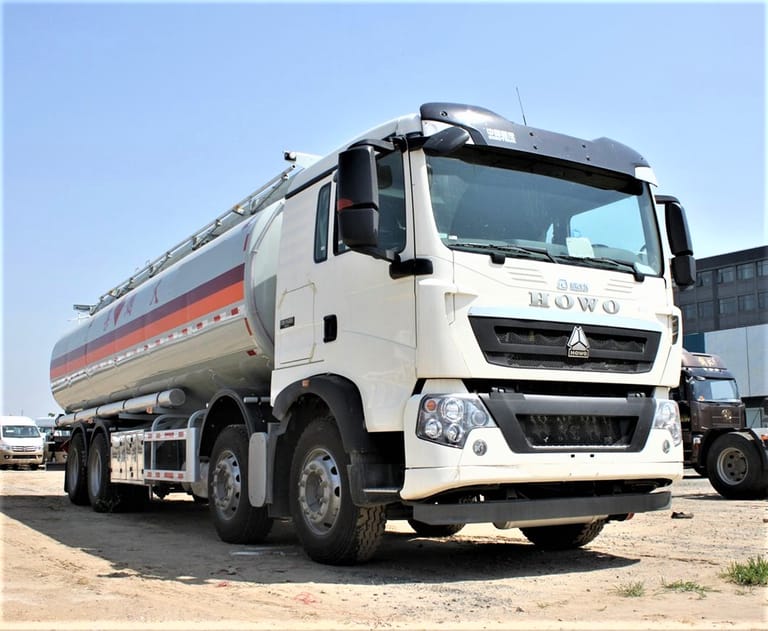 Front three-quarter view of HOWO 340HP 8×4 fuel tanker truck showing driver cabin and tank body Front three-quarter view of HOWO 340HP 8×4 fuel tanker truck showing driver cabin and tank body