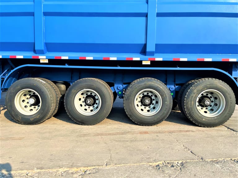 Close-up of tires on 4 Axle Dump Semi Trailer for Mining Coal – showing heavy-duty tires, strong rims, and reinforced suspension for mining operations. Close-up of tires on 4 Axle Dump Semi Trailer for Mining Coal – showing heavy-duty tires, strong rims, and reinforced suspension for mining operations.