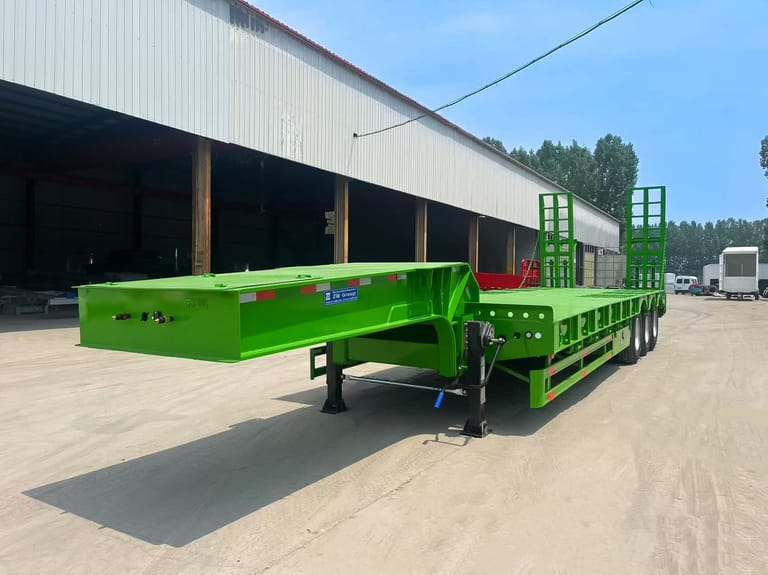 3 Axle Lowbed Semi Trailer front three-quarter view showing robust Q345 steel chassis and loading platform for heavy machinery transport. 3 Axle Lowbed Semi Trailer front three-quarter view showing robust Q345 steel chassis and loading platform for heavy machinery transport.