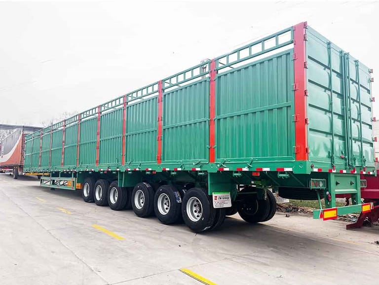 3/4 rear view of 6-Axle 100 Ton Cargo Transport Fence Semi-Trailer for Sale – showing reinforced chassis, tall fence structure, and rear gate for easy loading and unloading.