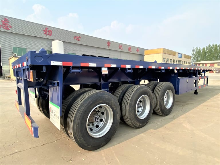 3/4 rear view of 40 ft Flatbed Semi Trailer for Sale — showing rear frame, tail structure, and flatbed platform designed for safe unloading of containers and heavy goods. 3/4 rear view of 40 ft Flatbed Semi Trailer for Sale — showing rear frame, tail structure, and flatbed platform designed for safe unloading of containers and heavy goods.