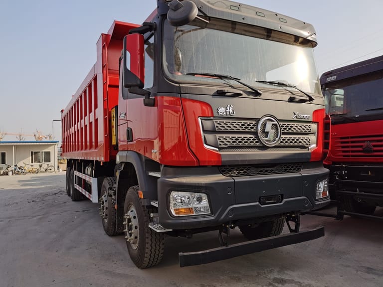 Shacman X3000 8X4 Dump Truck front 3/4 angle highlighting high-roof sleeper cabin, Euro VI Weichai engine, and rugged dual rear axles for robust hauling Shacman X3000 8X4 Dump Truck front 3/4 angle highlighting high-roof sleeper cabin, Euro VI Weichai engine, and rugged dual rear axles for robust hauling