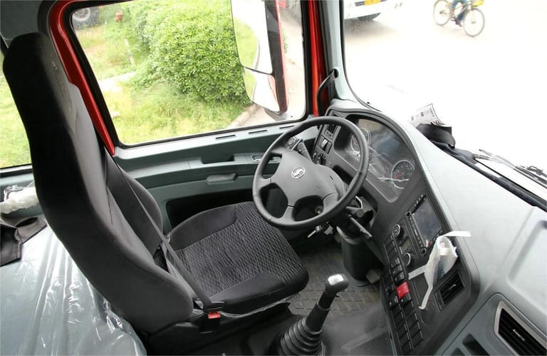 Shacman X3000 375HP 6x4 Tractor Truck high-roof extended sleeper cabin interior showing ergonomic driver seat, controls, air conditioning, and smart driving system Shacman X3000 375HP 6x4 Tractor Truck high-roof extended sleeper cabin interior showing ergonomic driver seat, controls, air conditioning, and smart driving system