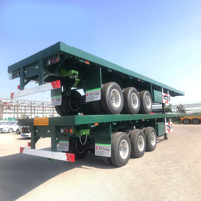 3 Axle Container Flatbed Trailer rear three-quarter view — showing the rear frame, twist locks, and reinforced chassis for secure container transport. 3 Axle Container Flatbed Trailer rear three-quarter view — showing the rear frame, twist locks, and reinforced chassis for secure container transport.