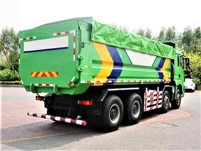 Shacman M3000 8x4 dump truck rear 3/4 angle showing cargo body, dual rear axles, and suspension system Shacman M3000 8x4 dump truck rear 3/4 angle showing cargo body, dual rear axles, and suspension system