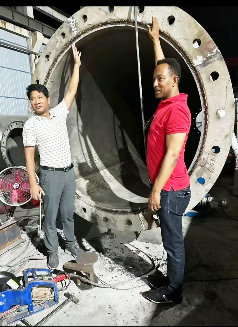 Client inspection of 100m ultra-tall flagpole base section at factory