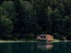 brown wooden house on lake