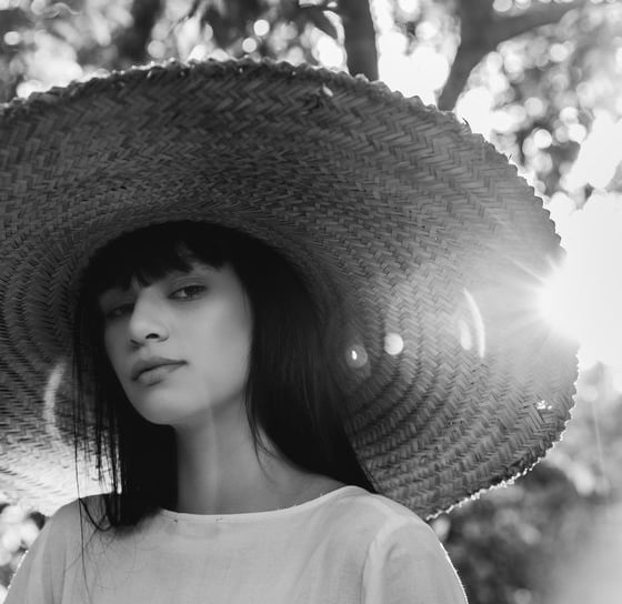 woman in white crew neck shirt wearing brown sun hat