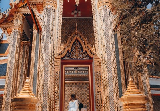 man and woman standing in front of brown concrete building during daytime