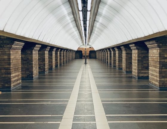 man in black jacket walking on hallway