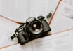 black nikon dslr camera on white printer paper