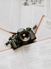 black nikon dslr camera on white printer paper