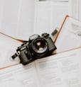 black nikon dslr camera on white printer paper