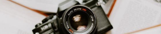 black nikon dslr camera on white printer paper