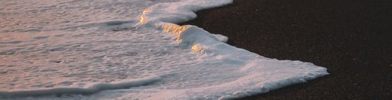 ocean waves crashing on shore during daytime