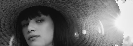 woman in white crew neck shirt wearing brown sun hat