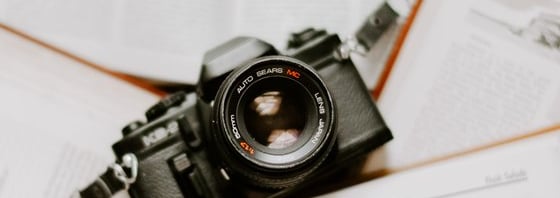 black nikon dslr camera on white printer paper