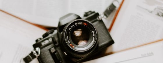 black nikon dslr camera on white printer paper