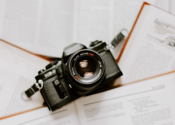 black nikon dslr camera on white printer paper