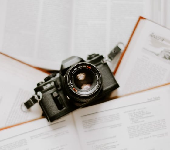 black nikon dslr camera on white printer paper