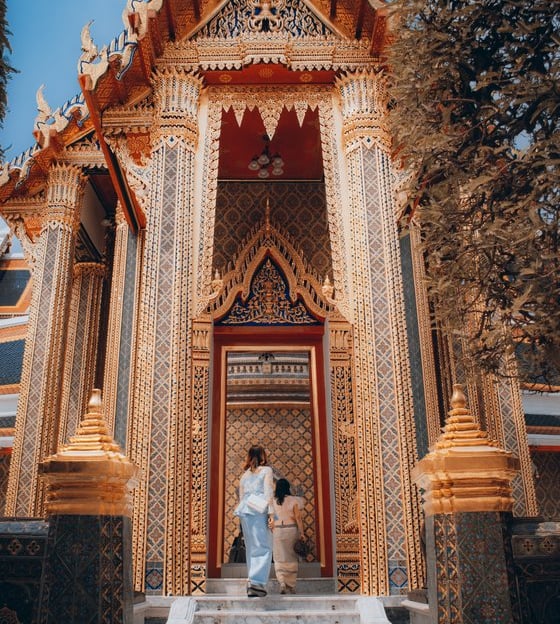 man and woman standing in front of brown concrete building during daytime