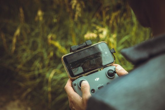 person holding black and gray digital camera